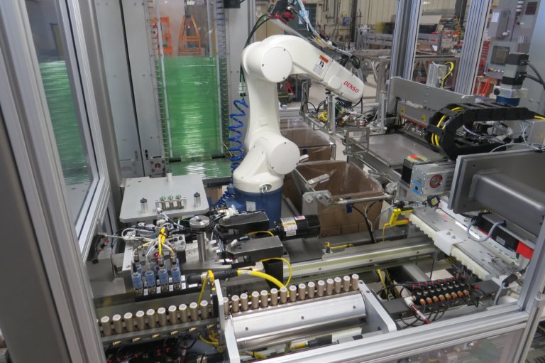 A DENSO robot for box packaging multiple product types.